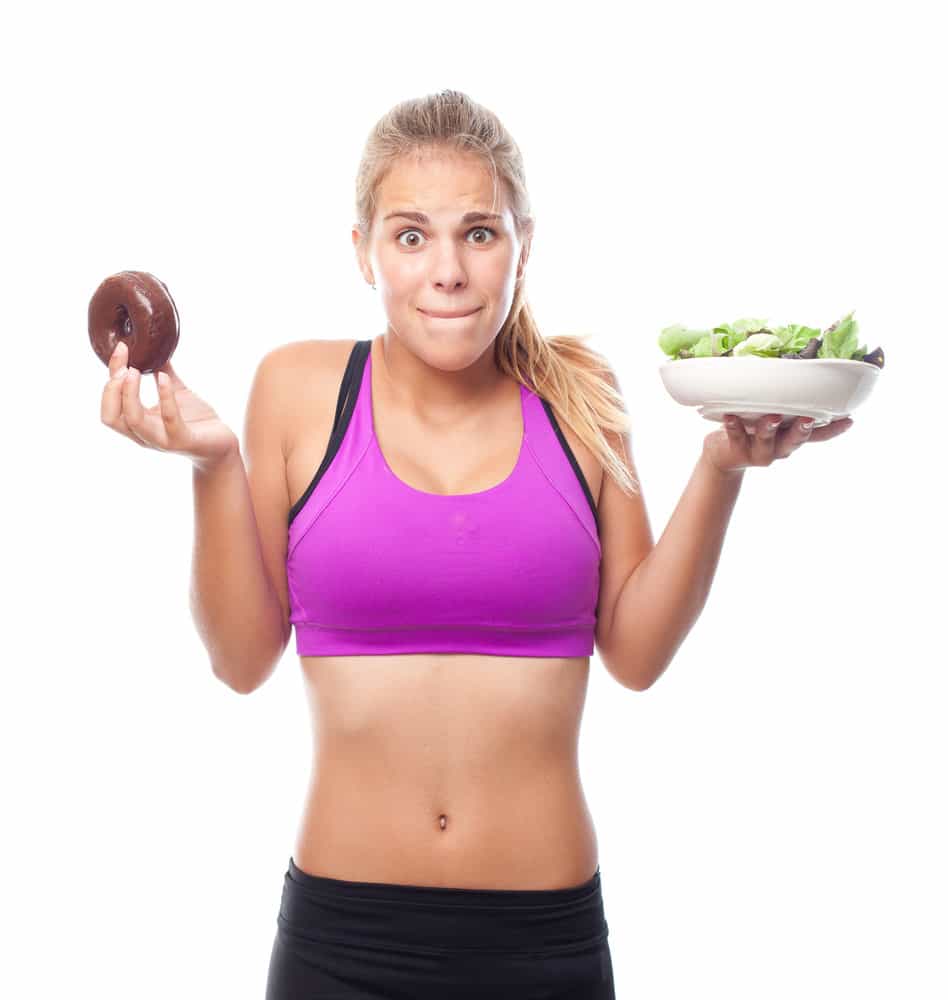 young cool woman doubting with donut and salad