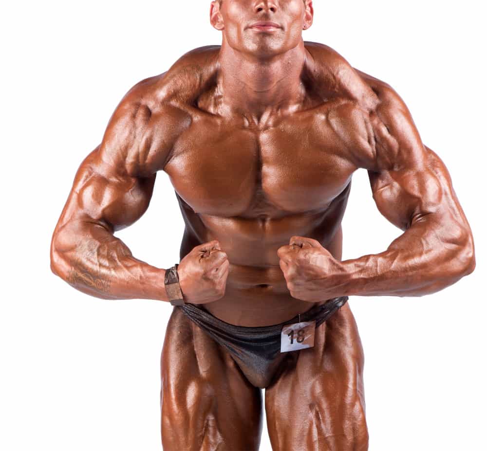 bodybuilder flexing his muscles in studio